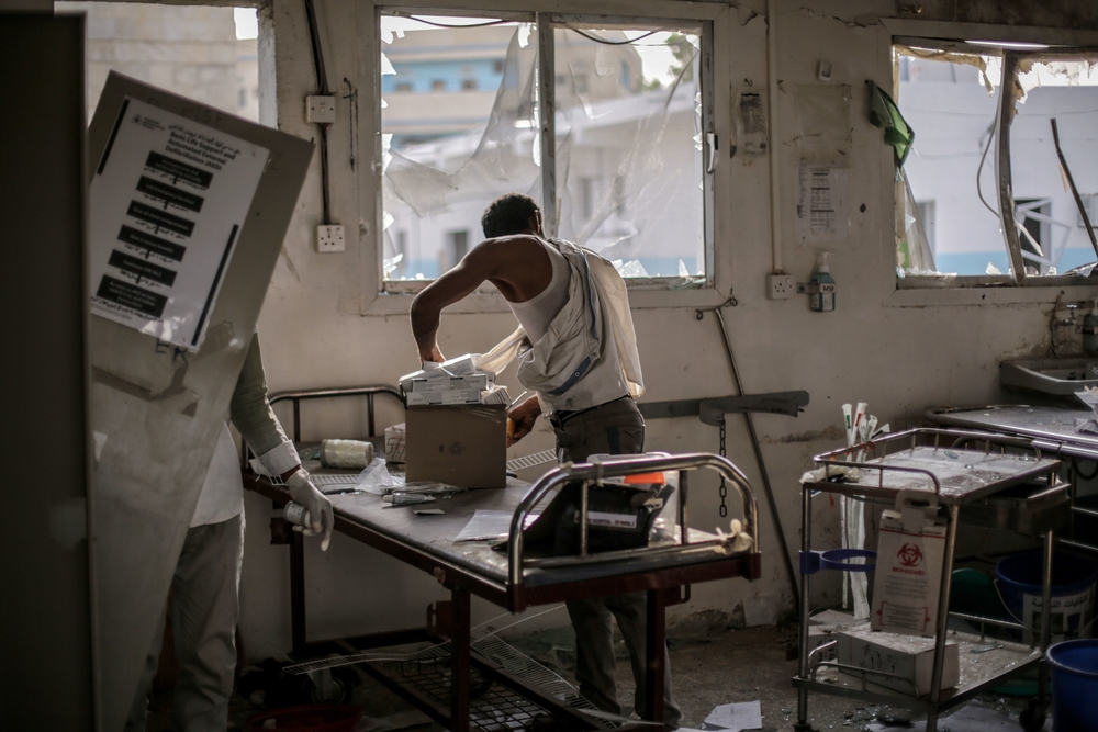 A hospital worker salvages the remains of undamaged medication and equipment left in the emergency room after the 15 August Saudi-led coalition airstrike which destroyed the hospital killing 19. In a country where access to healthcare is already extremely limited, the Abs hospital was the only facility catering to over 2,000 IDPs in the area and thousands more along the coast, from the northwestern border of Yemen to the outskirts of Hodeidah. With the destruction of Abs hospital, the closest hospital is now over three hours drive away.